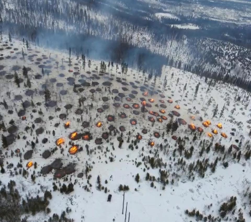 Aerial view of a slash pile burn unit in snow